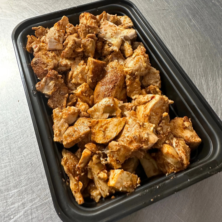 Bulk tray of seasoned diced chicken